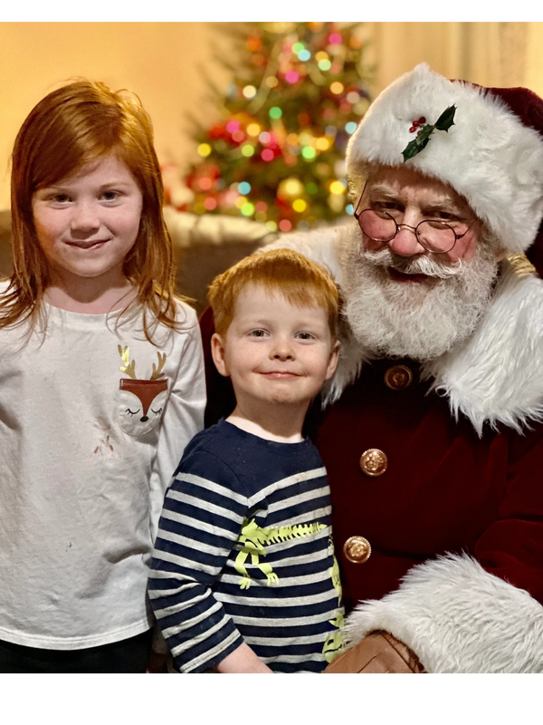 Real Bearded Santa Claus with two children during an authentic visit in Mercer County, New Jersey.