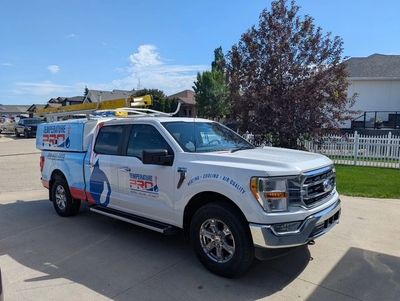 White utility truck with Temperature Pro branding parked on a residential Saskatoon street.