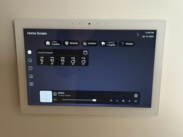 Smart home control panel displaying weather, security, lighting, and music settings.