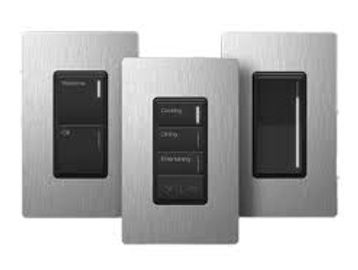 Three modern light switches with metallic finish and black buttons.