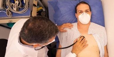 Doctor examining patient with stethoscope.