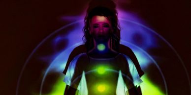 Person with chakra lights and colorful aura projection.