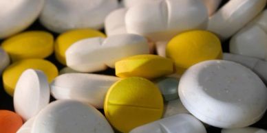 Close-up of white and yellow pills.