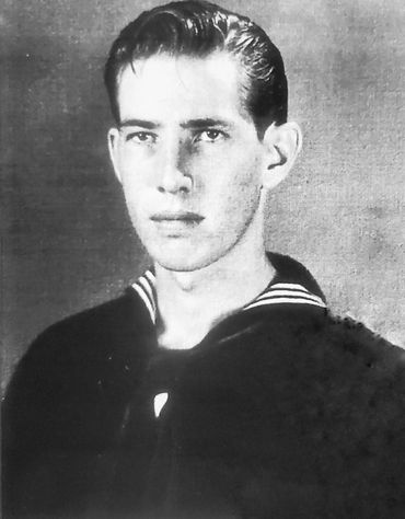Black and white portrait of a young man in a naval uniform.