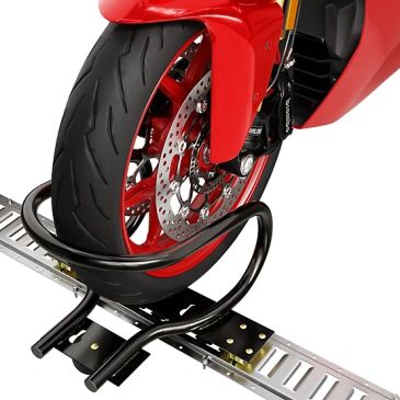 Front wheel of a red motorcycle secured in a wheel clamp.