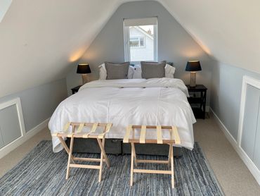 bedroom with lamps side tables and clothes rack