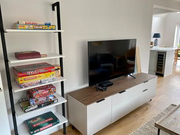 living room with board game shelf and flat-screen TV