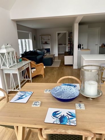 dining table with crawfish-themed placemats and a blue bowl