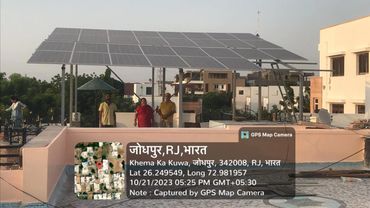 Solar panel installation with people working in Jodhpur, Rajasthan, India.