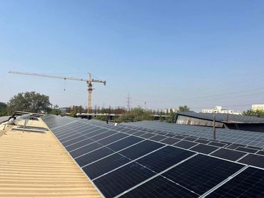 Solar panels installed on a rooftop under a clear blue sky.