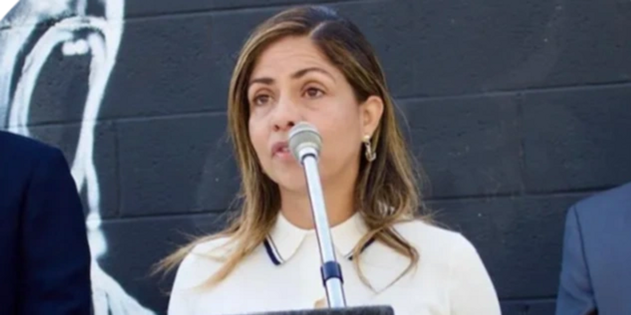 Woman speaking on a podium.