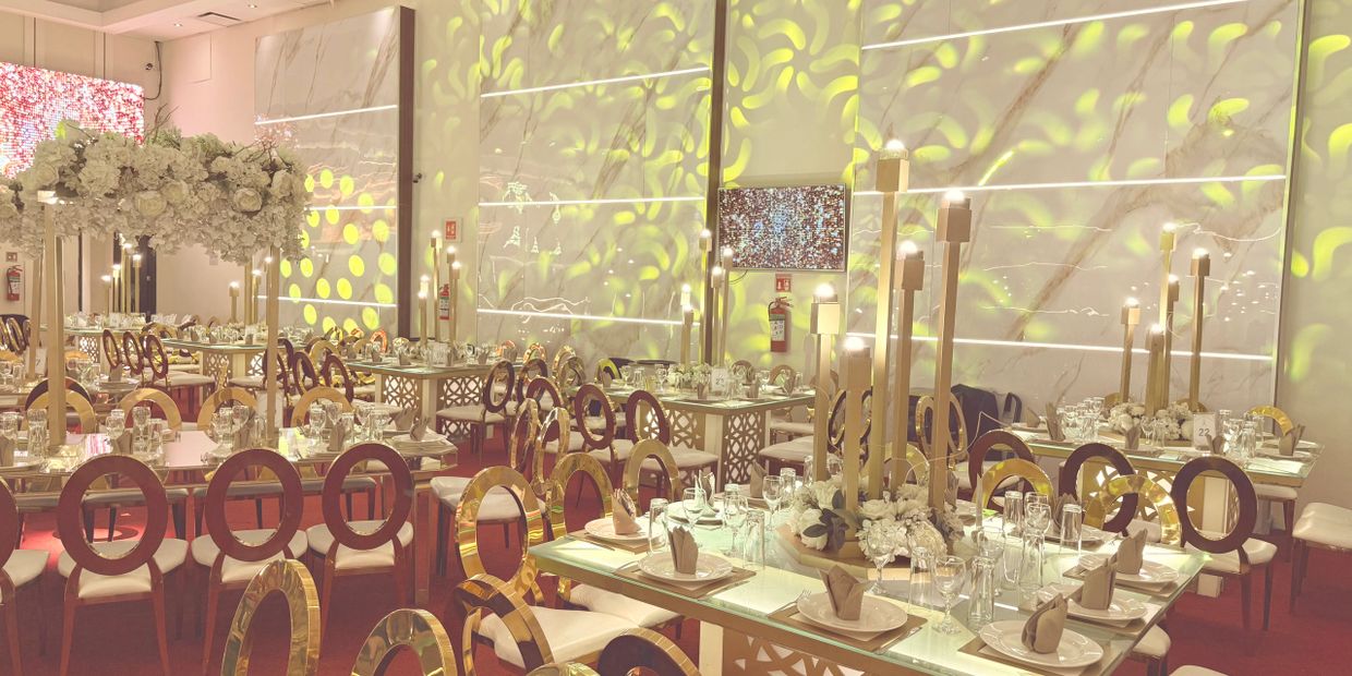 Elegant banquet hall with gold-accented chairs and floral centerpieces.