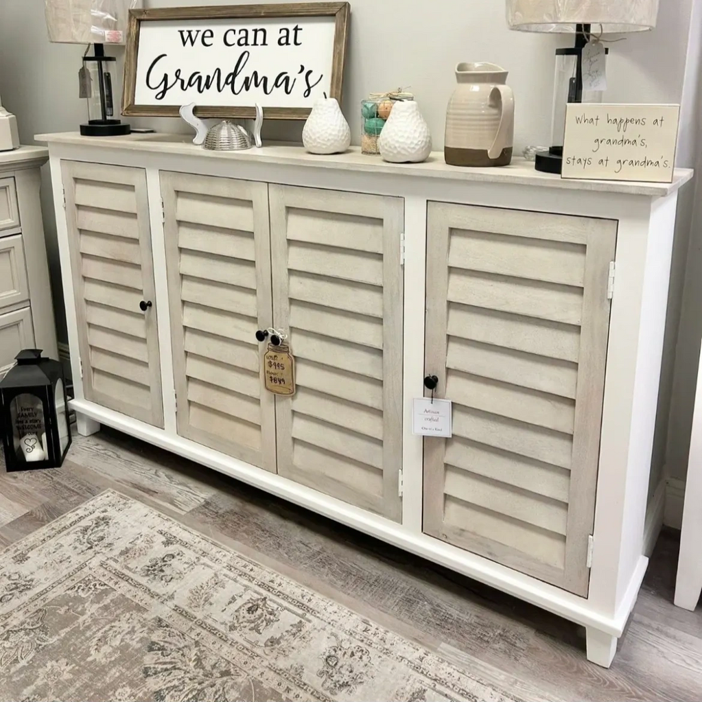Rustic cabinet with grandmother-themed decorative signs and ceramic items on top.