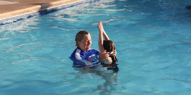 The Swim Center instructor teaches child swim techniques in McDonough GA Henry county best lessons