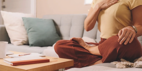 A Lady on the couch seated in meditation