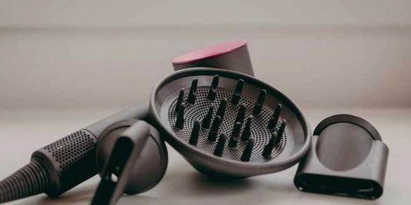 A close-up view of the Dyson Supersonic™ Hair Dryer and its attachments,