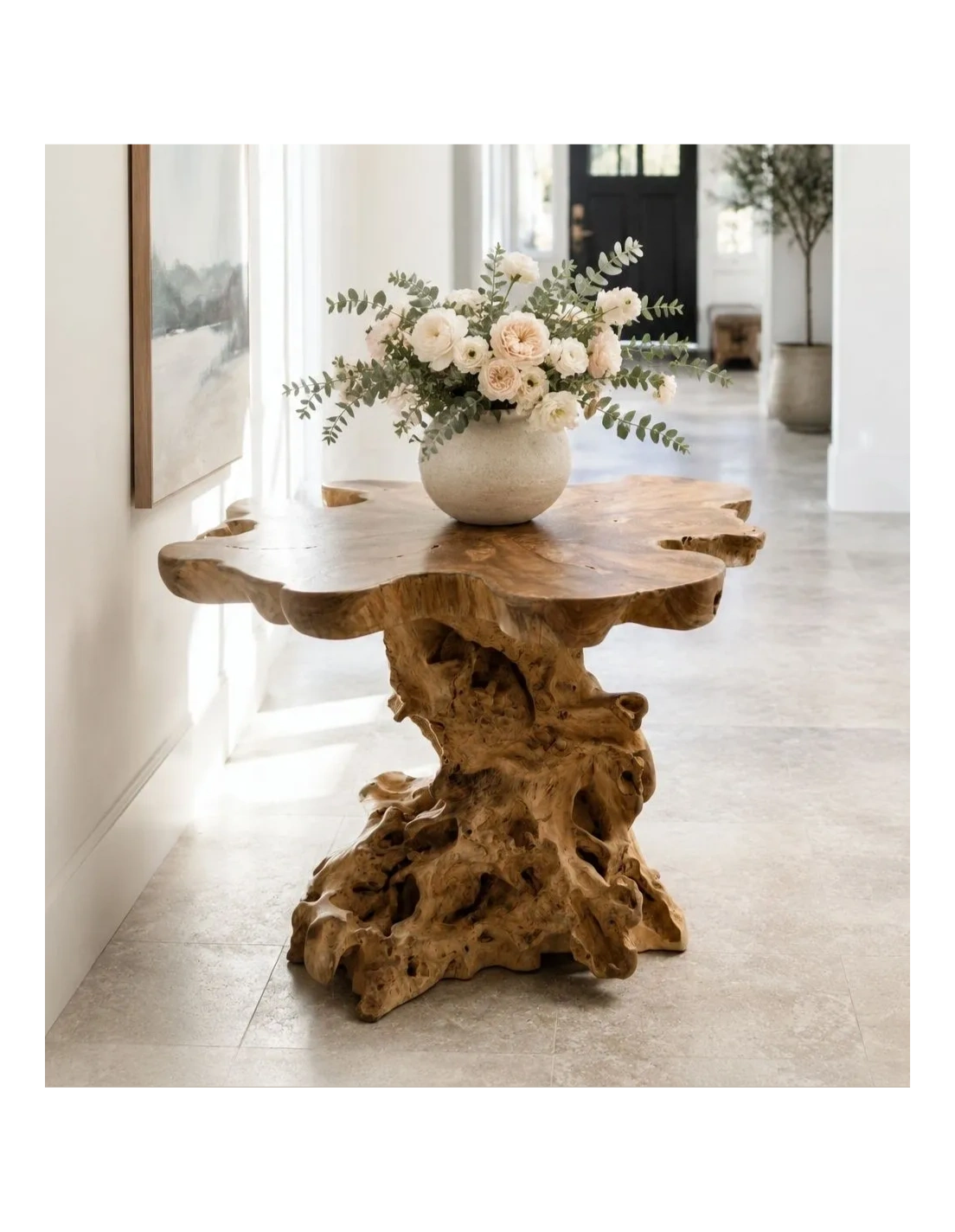 Rustic wooden table with a white flower arrangement in a bright hallway.