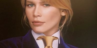 Portrait of a woman in a suit with a gold tie.