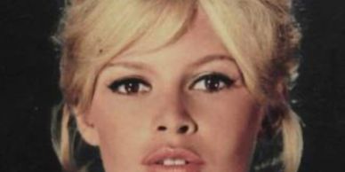Close-up portrait of a blonde woman with expressive eyes and natural makeup.