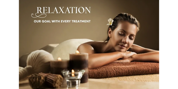 Woman receiving a calming day spa massage with candles at Salon Serenity Spa, Wake Forest, NC 27587