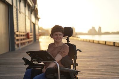 Siobhan Daley sitting in her power chair with her communication device 
