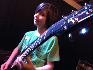 young kid playing guitar 
