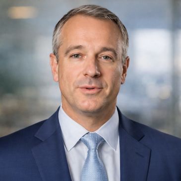 Professional man in suit and tie with a neutral expression.