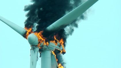 A wind turbine on fire due to oil used within the turbine for lubrication and hydraulics