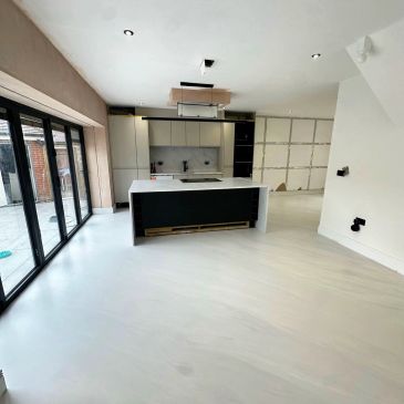 Modern minimalistic kitchen with island and large windows.