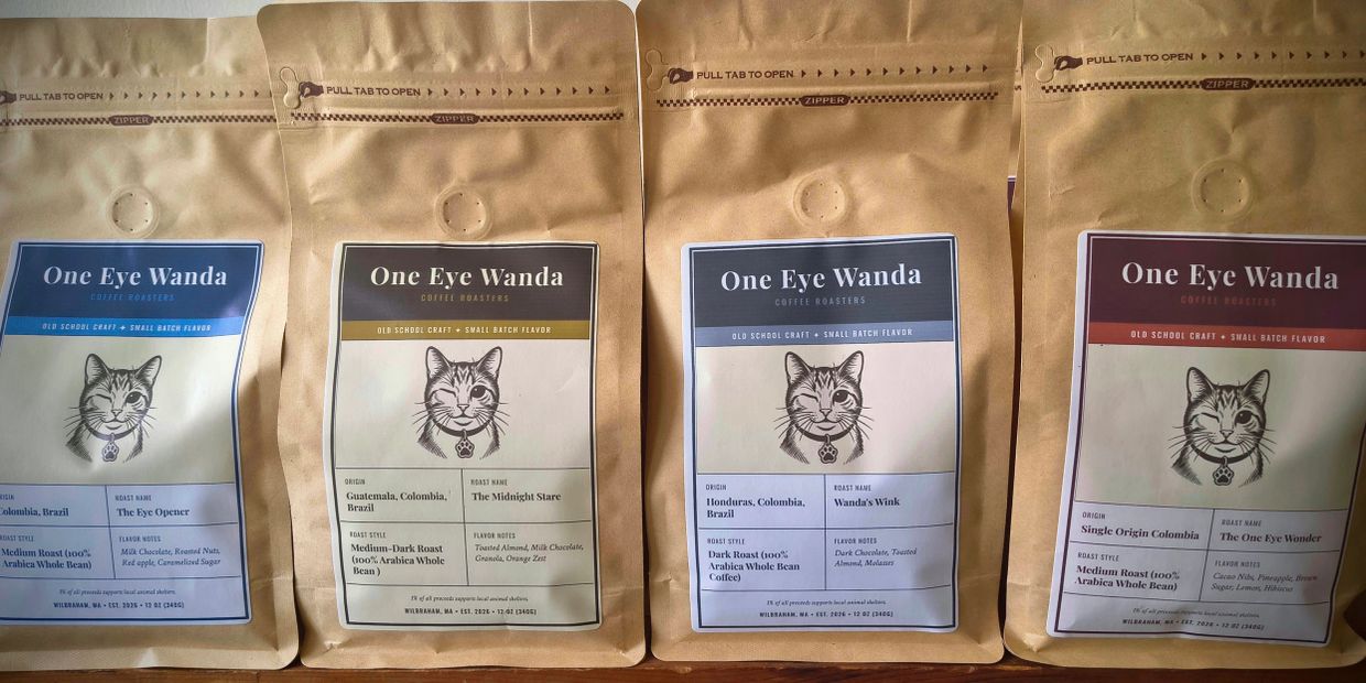 Four bags of One Eye Wanda coffee with different blends displayed.