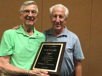 Bob Knopf receives thanks for years of service to Wellington from James Purvis