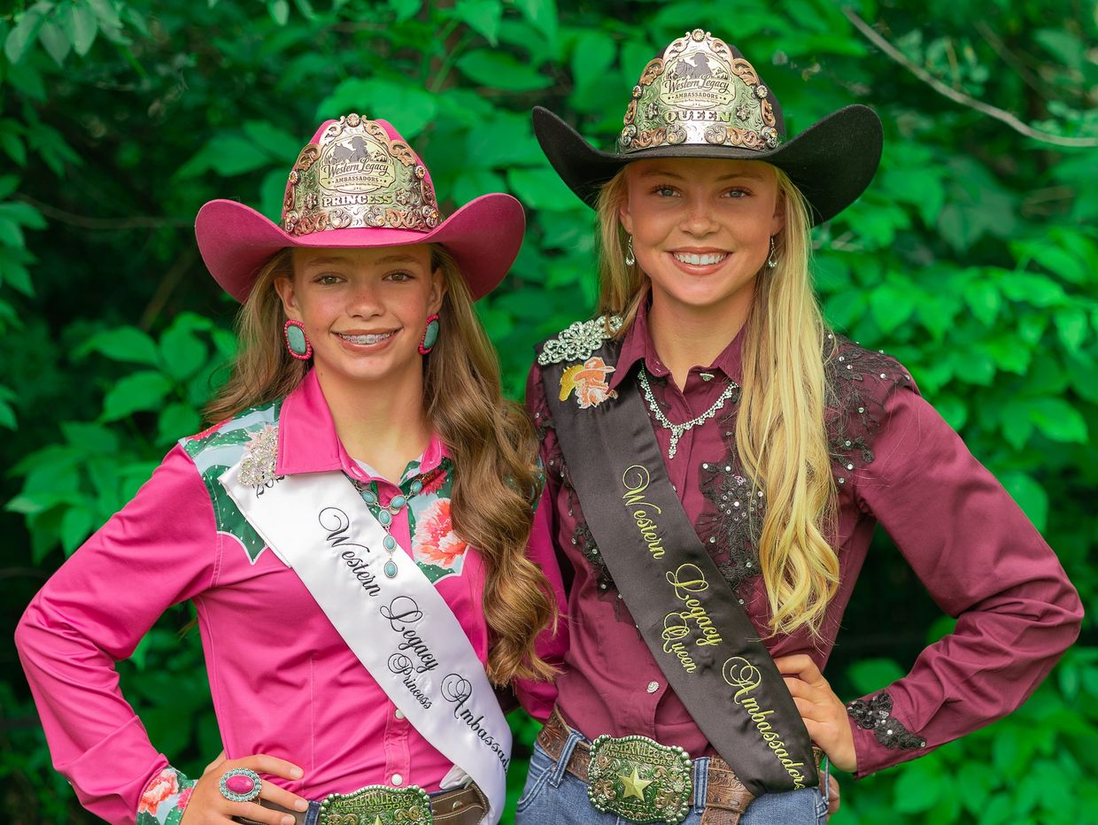 Two girls wearing Western Legacy Ambassador sashes and hats.