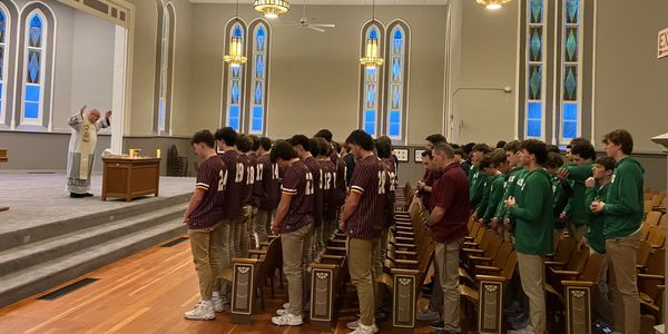 Students praying in a church during a service.