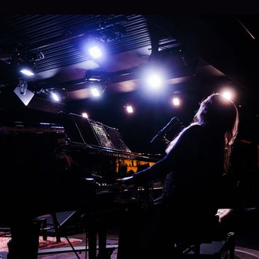 This is a poster of Ashlee Elmore playing the piano at a performance at Lowdown in Tulsa.