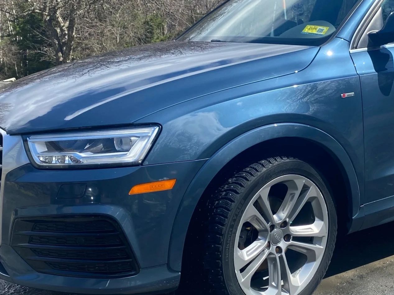Clean reflective paint of a blue audi q3