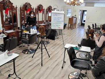 Cosmo Proof Instructor at Academy of Beauty School teaching Hair color techniques 