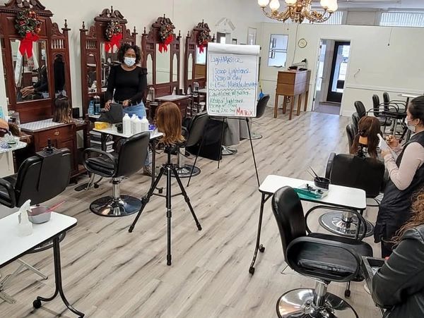 Cosmo Proof Instructor at Academy of Beauty School teaching Hair color techniques 