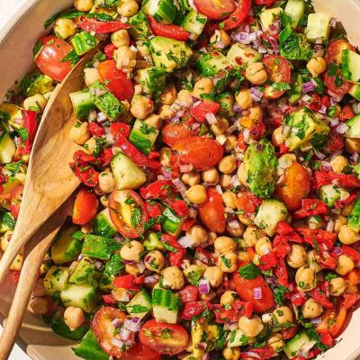 Colorful chickpea salad with fresh vegetables and herbs.