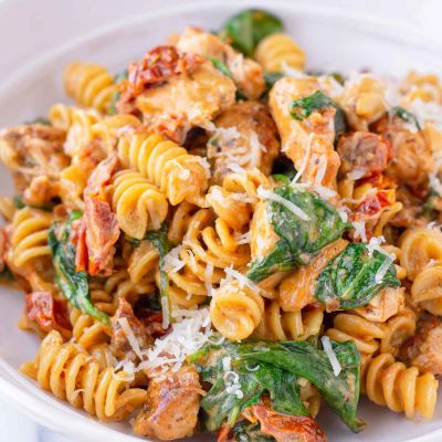 Creamy pasta with spinach, chicken, and sun-dried tomatoes.