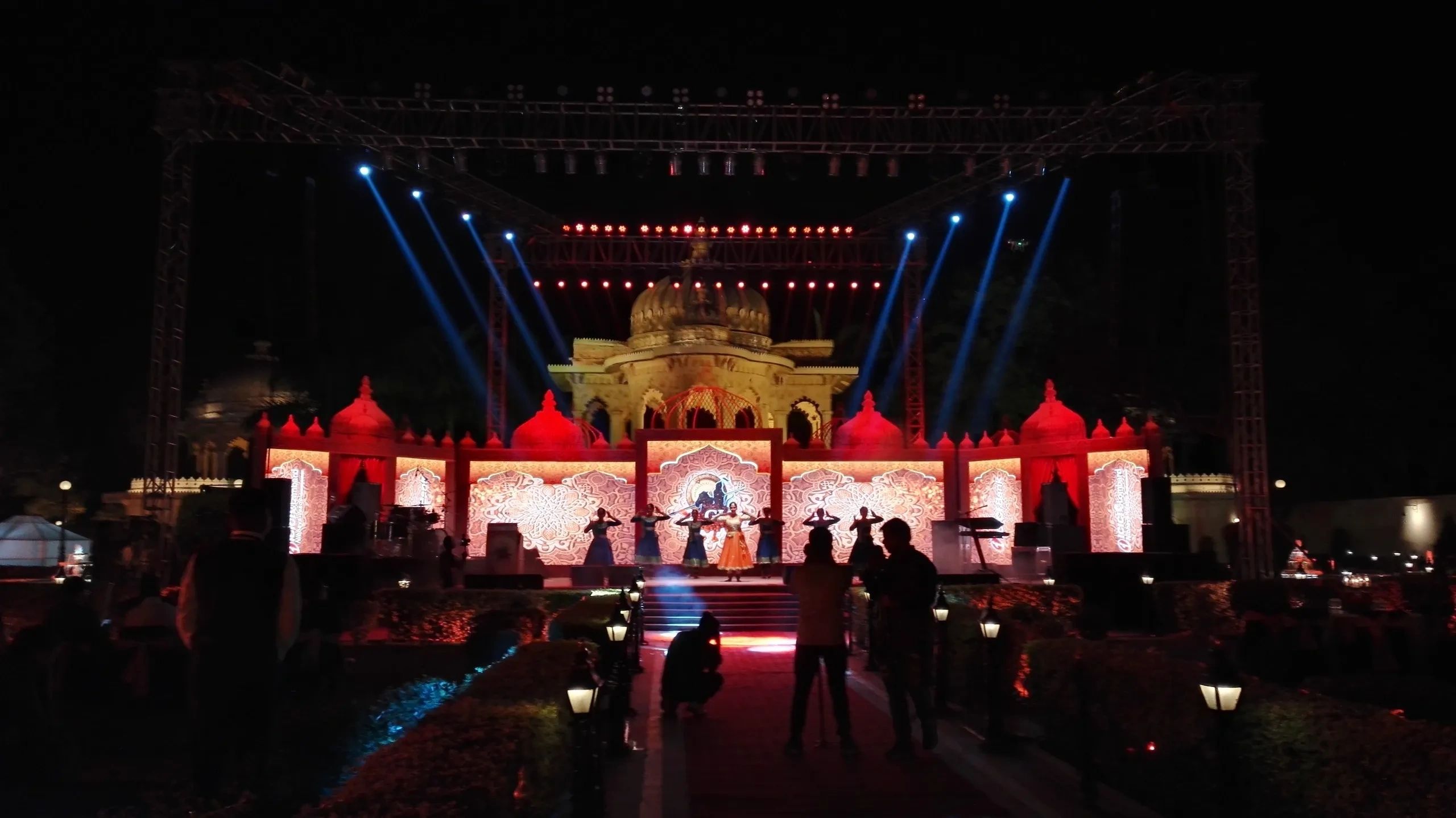 Main stage view of a corporate event.  Stage backdrop with light effects and artist performance