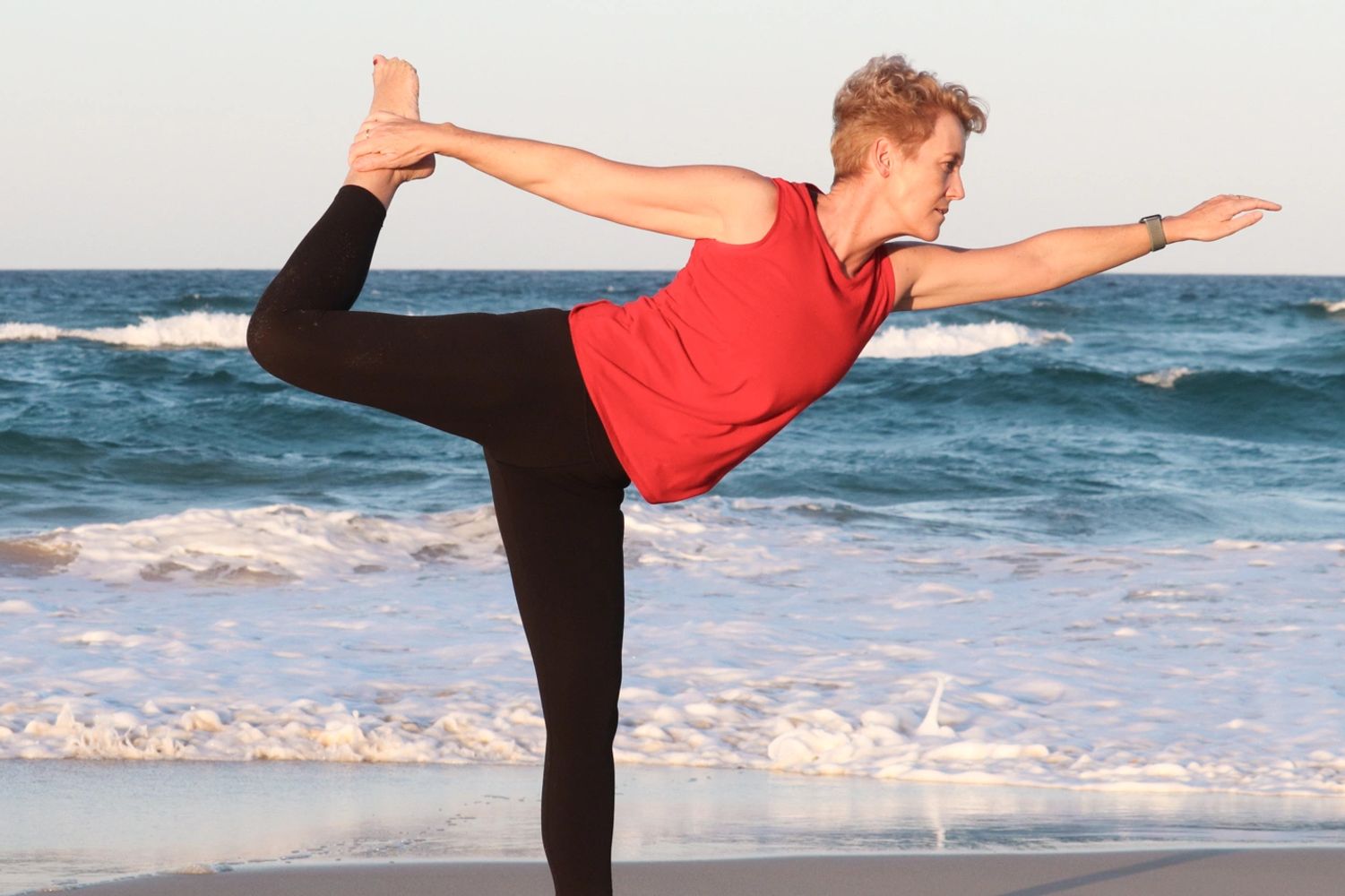 Simone Sukha in a Yoga Pose on the Beach