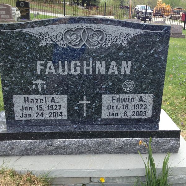 A dark granite gravestone for Hazel A. and Edwin A. Faughnan in a cemetery.