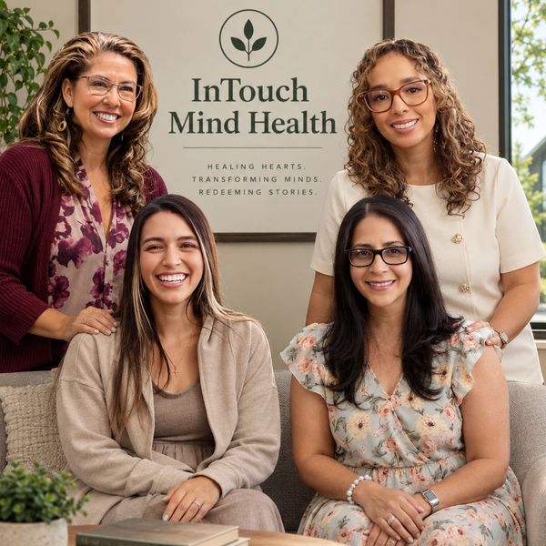 Four smiling women in a mental health office.
