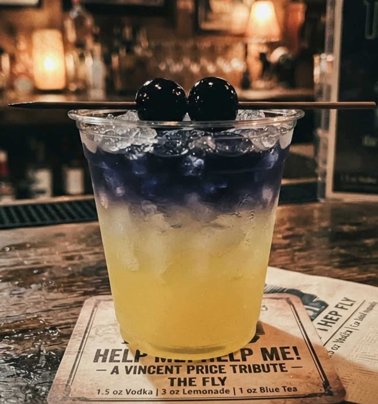 Colorful cocktail with cherries on top.