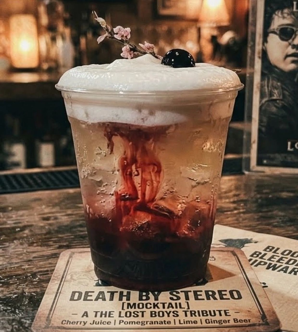A layered mocktail named Death by Stereo with cherry juice and pomegranate.