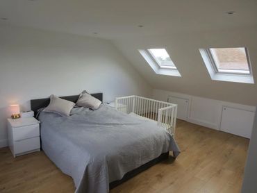 loft conversion bedroom with two Velux windows