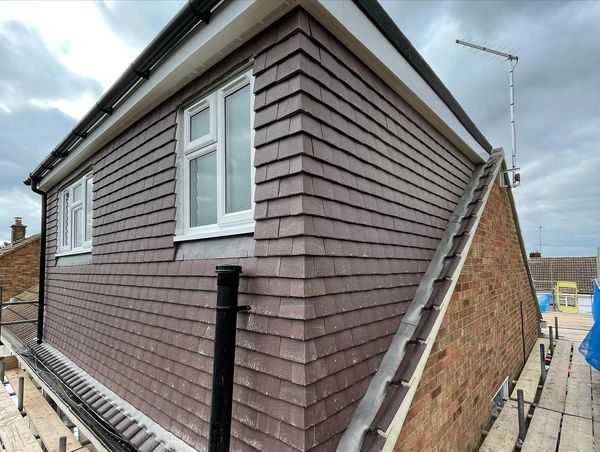 Dormer loft conversion with brown concrete tiles