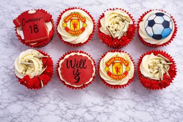 Soccer-themed cupcakes with Manchester United logos and personalized messages.