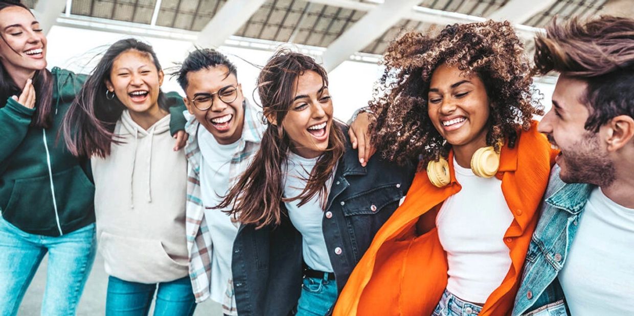 Group of friends laughing and enjoying time together outdoors.