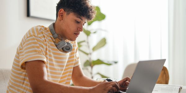 student working on a donated laptop